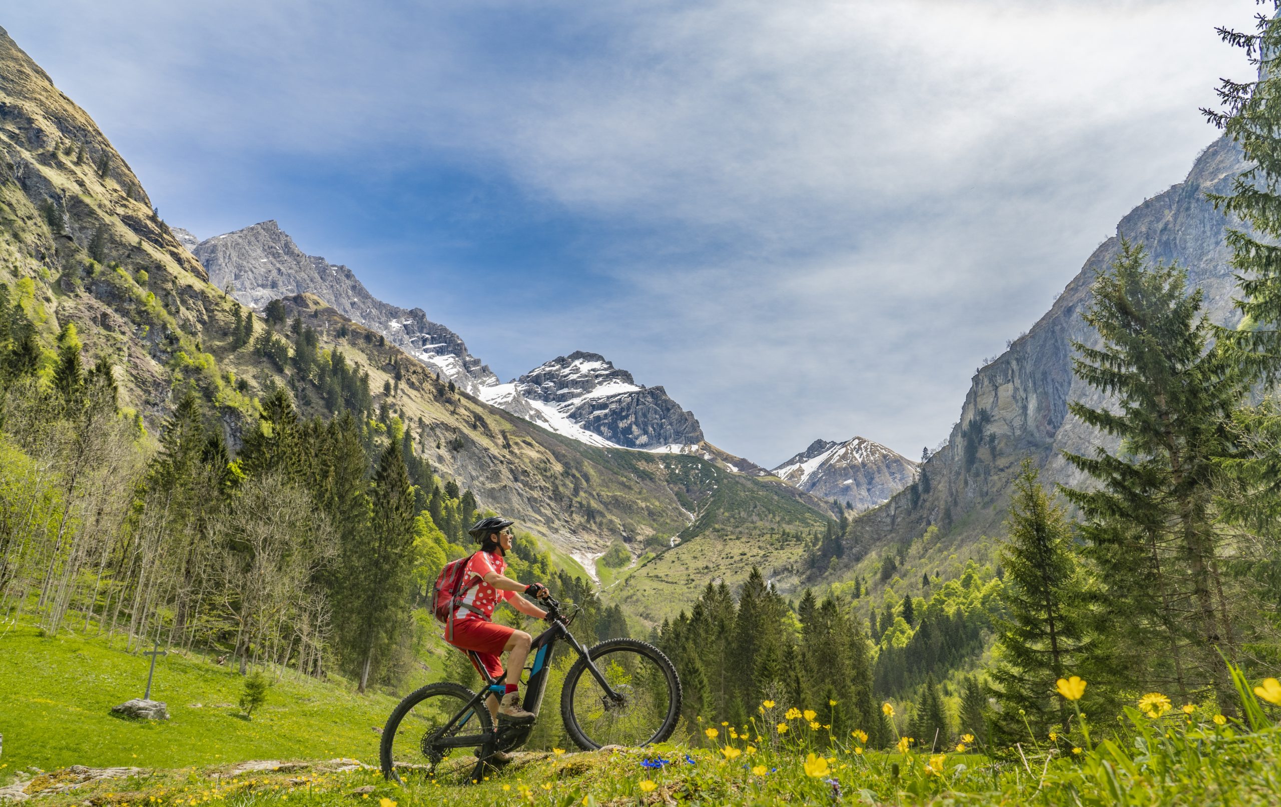 senior woman on electric mountainbike Winter skiing Swiss Alps - Alp Art Hotel